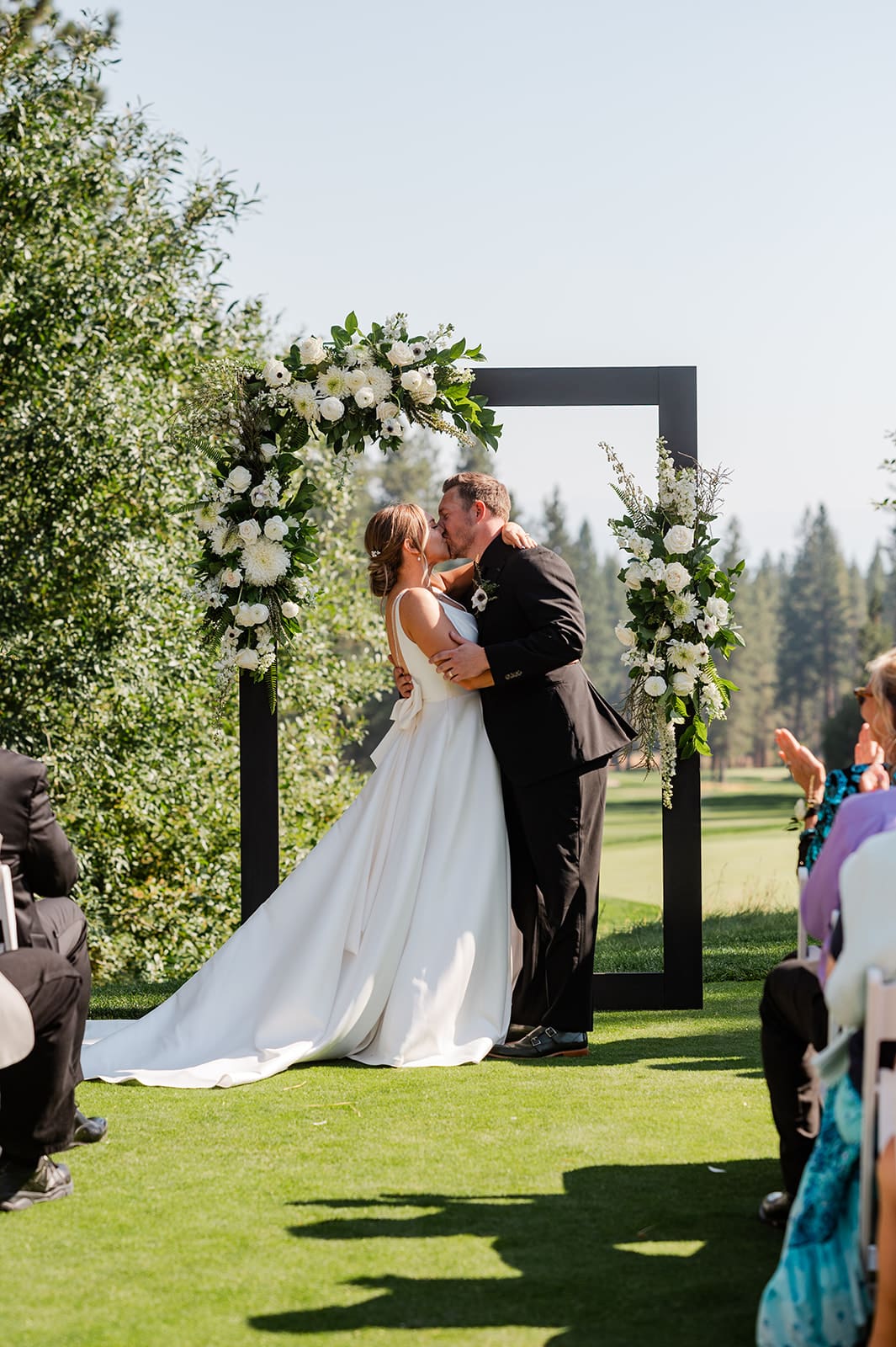 The couple having their first kiss during the ceremony